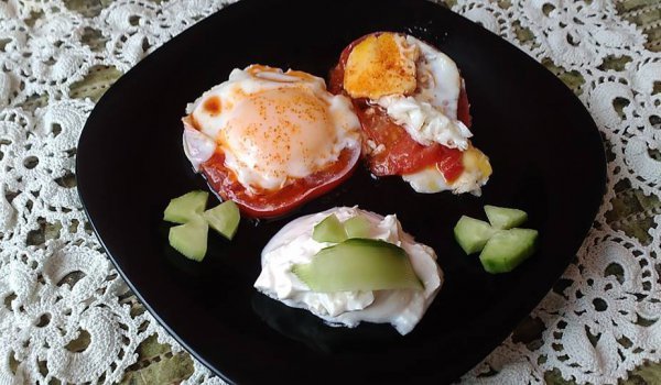 Яйца върху червени домати