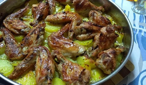 Пикантни крилца върху картофи